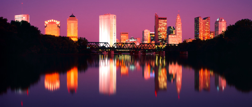 Columbus, Ohio skyline at sunset with the evening glow reflecting from the buildings.
